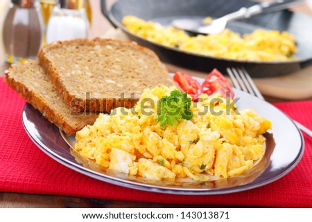 scrambled eggs with chives and herbs and two slices of bread