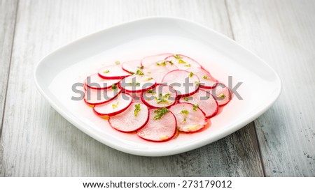 sliced radish salad with herbs and bread
