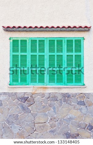 Detail of bright green shutters of a spanish house
