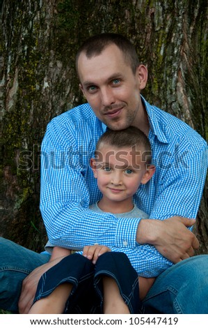 portrait of father and son in park