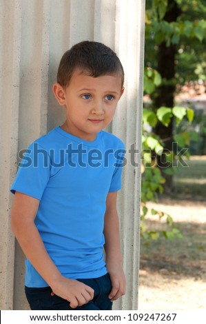 cute boy five years old posing outdoors