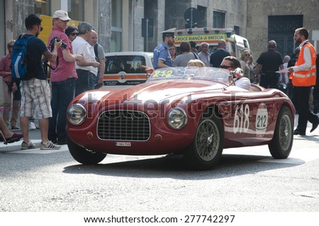 BRESCIA,ITALY - MAY,13:Registration of participants of the famous race retro cars Mille Miglia, May 13,2015 in Brescia,Italy. Driver Yves Despiegelaere on FIAT 1100 Barchetta Fontana, 1950 built
