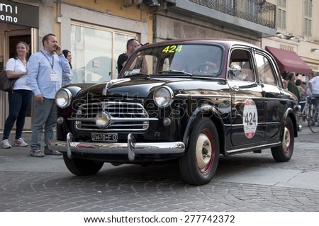 BRESCIA,ITALY - MAY,13:Registration of participants of the famous race retro cars Mille Miglia, May 13,2015 in Brescia,Italy. Driver Mauro Praga on FIAT 1100/103 TV berlina, 1956 built