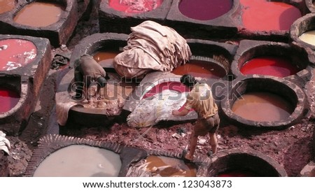 FEZ, MOROCCO - FEBRUARY 19: Unidentified men preparing to treat animal hides that will be dyed in this traditional Moroccan leather tannery on February 19, 2008 in Fez.