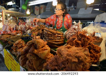 CHIANG MAI, THAILAND - FEBRUARY 16: Woman selling food at a street stall on February 16, 2014 in Chiang Mai, Thailand.