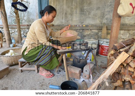 LUANG PRABANG, LAOS - MARCH 1: Unidentified woman preparing thread for weaving in silk on March 1, 2014 in Luang Prabang, Laos.