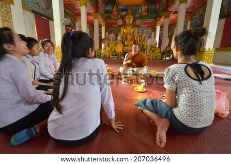 VIENTIANE, LAOS - MARCH 4: Unidentified women making an offering at Wat Hai Sok on March 4, 2014 in Vientiane, Laos