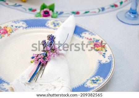 nosegay napkin ring on lace line napkin on a fancy dinner plate