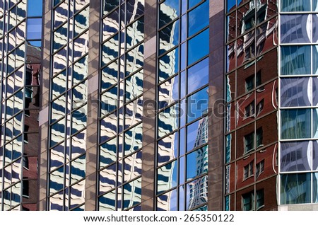 Chicago skyscrapers reflected in glass with blue sky