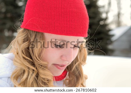 young Caucasian teenager with red knit cap