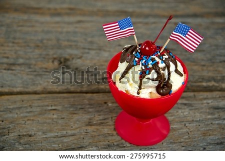 American flags in an ice cream sundae on rustic barn wood
