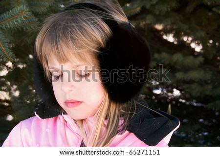 young girl wearing black fox fur earmuffs