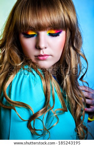 Beautiful woman with rainbow eye make-up
