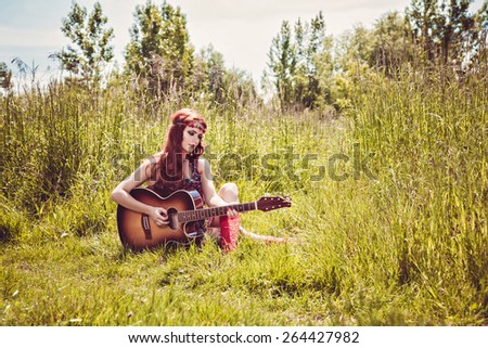 Romantic girl traveling with her guitar. Summer. Hippie style.