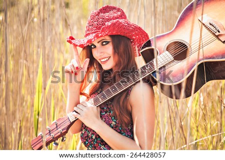 Romantic girl traveling with her guitar. Summer. Hippie style.