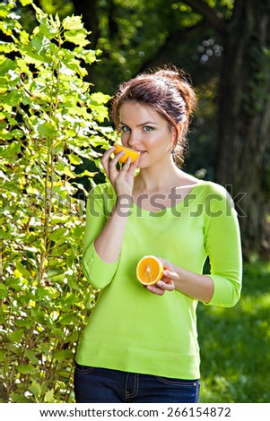 Young woman with with orange, healthy food concept, skin care and beauty, vitamins and minerals
