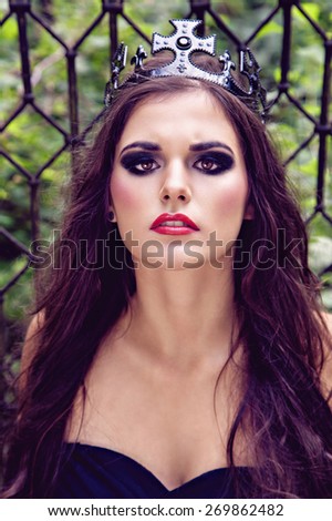 A creative photo of pretty brunette woman in black crown