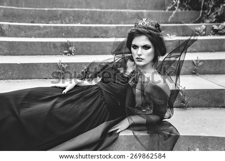 A creative photo of pretty brunette woman in black crown