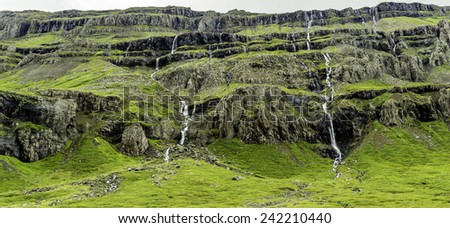 Waterfalls cascading down the mountain in east Iceland