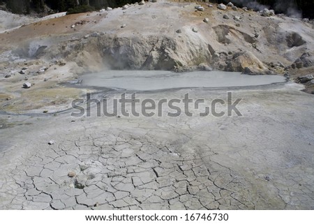 Volcanic hot spring pool and cracked earth in Lassen Volcanic National Park