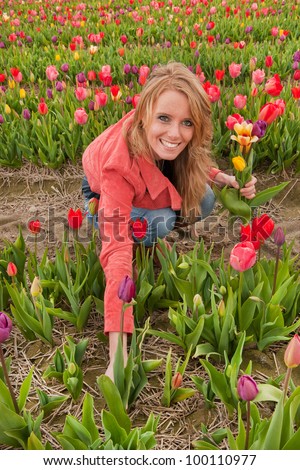 Portrait Of A Beautiful Blond Dutch Girl In Plucking Flowers In Tulips ...
