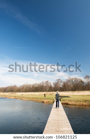 Wooden platforms in nature water lake with walking man