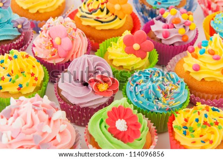 many sweet birthday cupcakes with flowers and butter cream