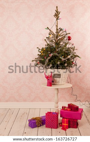 Christmas tree on table in vintage room