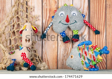 Stuffed colorful handmade funny toys at home on wooden background