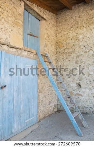 Old French bard with blue doors and stairs