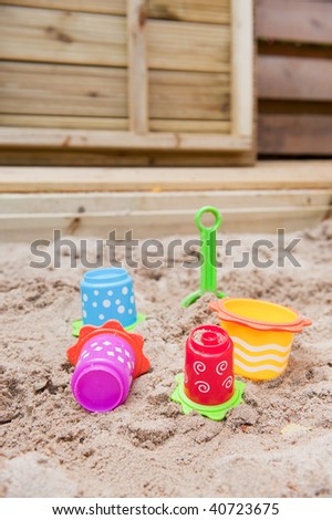 Plastic colorful toys in the sand box to play with