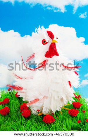 Funny white decoration chicken in the grass
