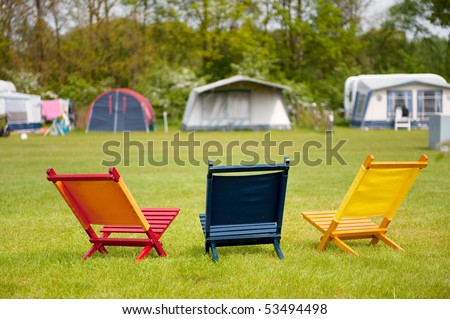 Campground with colorful empty chairs to sit down