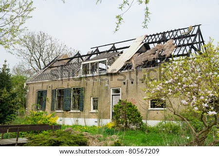 Damaged burned house with straw roof in Holland
