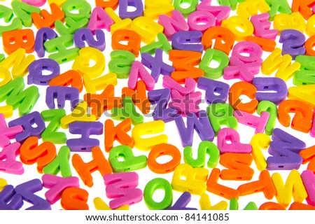 Colorful letter chaos with foam on white background