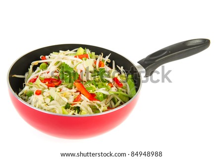 Red wok pan with mixed Chinese vegetables