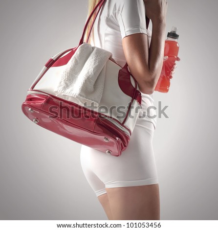 Athletic woman with a sports bag and sports drink