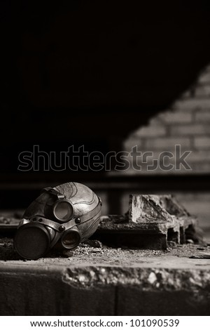 a old gas mask on a dirt concrete floor