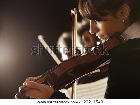 Violinist woman playing a concert of classical music