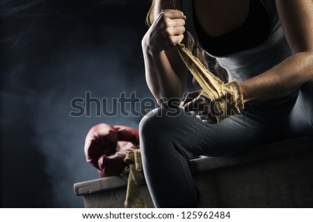 Woman boxer wearing white strap on wrist