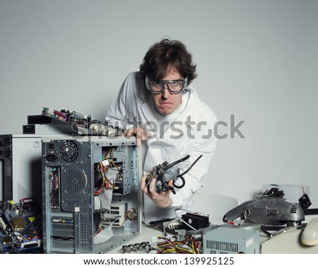 Portrait of a Computer technician with a computer destroyed