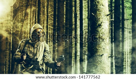 A soldier wearing gas mask is fighting in the forest