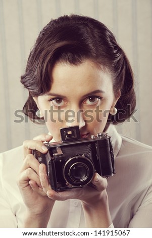Beautiful business woman with a old camera