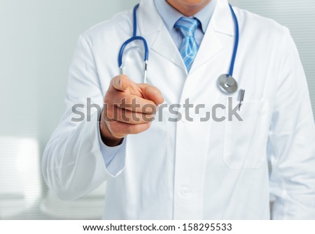 Medical doctor pointing at you, close up