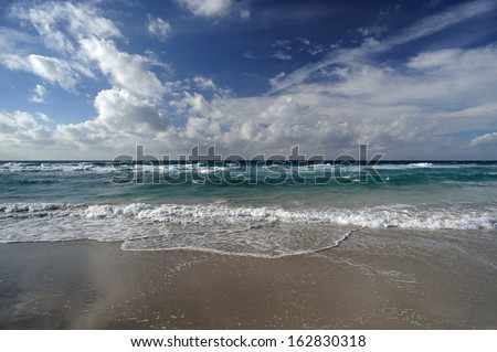 Landscape with sea and sand, white clouds in the sky