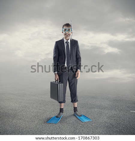 Businessman wearing scuba mask and flippers.
