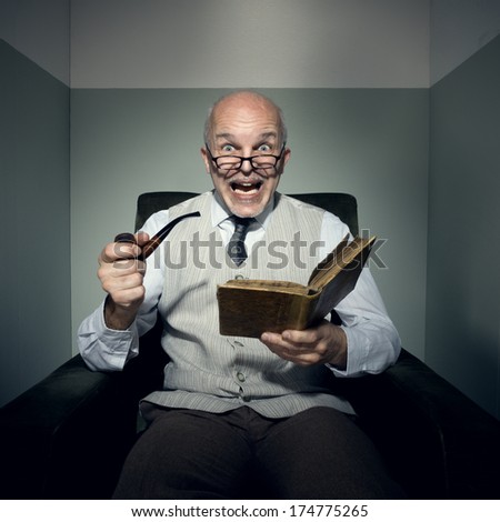 Senior shocked man reading in armchair and smoking pipe.