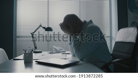 Similar – Image, Stock Photo Sad, exhausted doctor sitting in a dark room