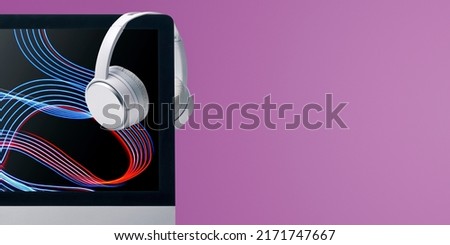 Computer with sound waves video and wireless headphones, online video and music entertainment Сток-фото © 