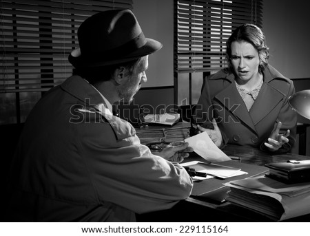 Handsome detective at office desk showing a picture to a young woman, film noir scene.